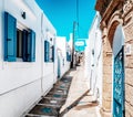 Quiet aisle in greek village Koskinou with typical white houses and blue shutters on windows at Rhodes island in Greece