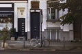 Quiet autumn afternoon on the streets in Brussels. Bicycle parked in front of elegant dark blue door