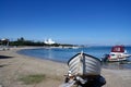 Quiet beach on the island of Agistri, Greece. Small pleasure boats moored in the beautiful bay.