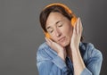 Quiet beautiful middle aged woman listening to relaxing music