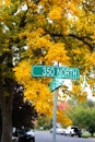 Quiet city street corner with vibrant autumn leaves Royalty Free Stock Photo