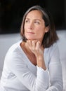 Quiet contemplation. an attractive mature woman looking thoughtful while sitting on her bed.