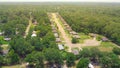 Quiet cul-de-sac, residential street along row of new development single family homes surrounding by lush green trees near Royalty Free Stock Photo