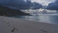 A quiet evening on the beach. Footprints along the edge of the ocean Royalty Free Stock Photo