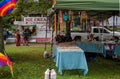 Quiet jewelry stand at Pride Fest with lunch truck background