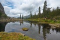 A quiet lake among rocks and dense taiga Royalty Free Stock Photo