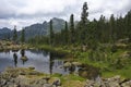 A quiet lake among rocks and dense taiga Royalty Free Stock Photo