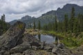 A quiet lake among rocks and dense taiga Royalty Free Stock Photo