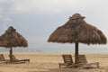 Quiet moments at the beach,on lounge chairs under tiki huts