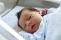 Quiet newborn baby in hospital cot Royalty Free Stock Photo