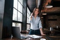 Quiet and nice interior. Businesswoman in official clothes is indoors in cafe at daytime