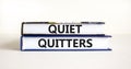 Quiet quitters symbol. Concept words Quiet quitters on books. Beautiful white table white background. Business and quiet quitters