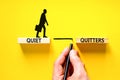 Quiet quitters symbol. Concept words Quiet quitters on wooden blocks. Beautiful yellow table yellow background. Businessman hand.