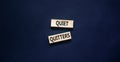 Quiet quitters symbol. Concept words Quiet quitters on wooden blocks. Beautiful black table black background. Business and quiet