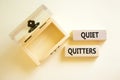Quiet quitters symbol. Concept words Quiet quitters on wooden blocks. Beautiful white table white background. Empty wooden chest.