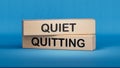 Quiet quitting symbol. Concept words Quiet quitting on wooden blocks.Businessman hand.