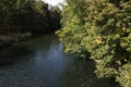 A quiet river with overgrown green banks