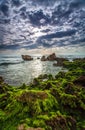 Quiet sea with rough rock and overcasted sky Royalty Free Stock Photo