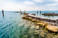Quiet shore of Lake Garda on a rainy day near the empty jetty Royalty Free Stock Photo