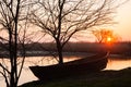 Quiet spring sunset on the lake with a boat Royalty Free Stock Photo