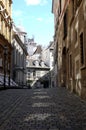 Calm stone paving city street with old vintage houses in the center of Vienna on bright sunny day