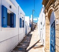 Quiet street in greek village Koskinou with typical white houses and blue shutters on windows at Rhodes island in Greece