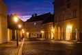 Quiet street of Prague, the capital of Czech Republic. Empty cobblestone road lit by vintage lamps under the colorful sky. Royalty Free Stock Photo