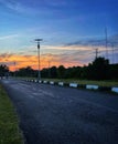 Quiet Suburban Asphalt Road at Dramatic Sunset with Solar Light Royalty Free Stock Photo