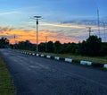 Quiet Suburban Asphalt Road at Dramatic Sunset with Solar Light Royalty Free Stock Photo