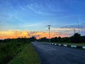 Quiet Suburban Asphalt Road at Dramatic Sunset with Light Solar Panel Royalty Free Stock Photo