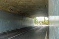 a quiet underpass tunnel road with no vehicles passing by during the day