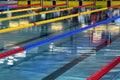 Quiet water in swimming pool - red, blue and yellow lane lines Royalty Free Stock Photo