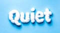 Quiet word crafting using soft white cotton balls on blue background Royalty Free Stock Photo