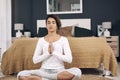 Quiet your storms before they deafen you. an attractive young woman meditating on her bedroom floor at home. Royalty Free Stock Photo