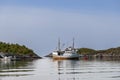 A fishing boat reflects in the calm waters of a quiet Lofoten inlet Royalty Free Stock Photo