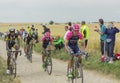 Group of Cyclists Riding on a Cobblestone Road - Tour de France Royalty Free Stock Photo