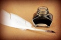 Quill pen and glass ink bottle