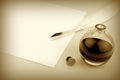 Quill pen and glass ink bottle with paper Royalty Free Stock Photo