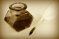 Quill pen and glass ink bottle, sepia style