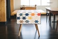 quilt with stitched constellation patterns laid on table