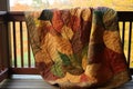 quilted blanket with seasonal designs, like autumn leaves