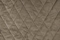 Quilted brown velours fabric background, wrinkled soft blanket surface