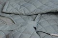 Quilted long jacket. Lying on the table. Close-up Royalty Free Stock Photo
