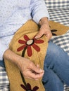 Quilter hand sewing wool floral pattern