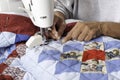 A quilter machine quilting patriotic quilt.