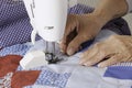 Quilter machine quilting patriotic quilt. Royalty Free Stock Photo