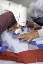 Quilter machine quilting patriotic quilt.