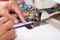 Quilter sewing on binding to quilt. Royalty Free Stock Photo