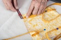 A quilter uses a ruler to position strap
