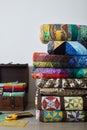 Quilts stacked, quilting accessories and wooden chest with stacks of fat quarters Royalty Free Stock Photo